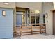 Modern home entrance with a blue door, contemporary fence, and desert landscaping at 10228 Shell Star Ave, Las Vegas, NV 89135