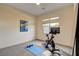 Exercise room featuring a stationary bike, dumbbells, and a yoga mat; ideal for home workouts at 10228 Shell Star Ave, Las Vegas, NV 89135