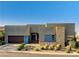 Modern home with a gray exterior, contrasting stone accents, and desert landscaping at 10228 Shell Star Ave, Las Vegas, NV 89135