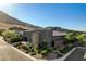 Aerial view showcasing a modern home with desert landscaping and mountain views at 10228 Shell Star Ave, Las Vegas, NV 89135
