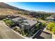 Aerial view showcasing a modern home surrounded by desert landscape and mountains at 10228 Shell Star Ave, Las Vegas, NV 89135