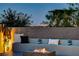 Relaxing rooftop terrace with a fire pit and city views at dusk at 10228 Shell Star Ave, Las Vegas, NV 89135