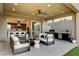 Inviting outdoor space with plush seating, outdoor kitchen, and seamless transition to the indoor kitchen at 10228 Shell Star Ave, Las Vegas, NV 89135