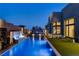 Stunning backyard featuring a modern pool, a sleek waterfall feature and an upper deck with a fire pit at 10228 Shell Star Ave, Las Vegas, NV 89135