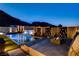 Stunning pool area with water features, modern decor, and mountain views at twilight at 10228 Shell Star Ave, Las Vegas, NV 89135