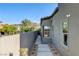 Landscaped side yard walkway featuring gravel, pavers, and desert plants at 10228 Shell Star Ave, Las Vegas, NV 89135