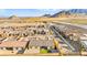 A drone shot of a community showcasing a single-Gathering home with desert landscaping and community mountain views at 10906 Mila Landing Ave, Las Vegas, NV 89166