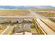 A high-angle shot displays homes and the surrounding desert landscape in the area at 10906 Mila Landing Ave, Las Vegas, NV 89166