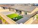 Aerial view of the backyard with a compact lawn, patio furniture, and gravel for low-maintenance landscaping at 10906 Mila Landing Ave, Las Vegas, NV 89166