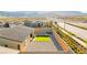 Aerial view of backyard with decorative rock, small lawn, patio, and string lights at 10906 Mila Landing Ave, Las Vegas, NV 89166
