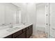 The bright bathroom boasts a double vanity and bright, neutral tile at 10906 Mila Landing Ave, Las Vegas, NV 89166