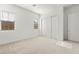 This bedroom features a large closet, large windows, and bright, neutral paint at 10906 Mila Landing Ave, Las Vegas, NV 89166
