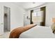 Natural light fills this neutral bedroom with an ensuite and walk-in closet at 10906 Mila Landing Ave, Las Vegas, NV 89166