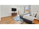 Bright bedroom featuring hardwood floors, a modern ceiling fan, and a well-lit ensuite access at 10906 Mila Landing Ave, Las Vegas, NV 89166