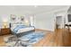 Bright bedroom with hard wood floors, stylish bed, modern decor, and natural light with ensuite access at 10906 Mila Landing Ave, Las Vegas, NV 89166