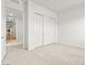 A bedroom featuring double door closet and neutral color palette at 10906 Mila Landing Ave, Las Vegas, NV 89166