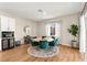 Bright dining room with a round table, stylish green chairs, and modern lighting with bar and wine storage at 10906 Mila Landing Ave, Las Vegas, NV 89166