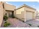 Inviting home entrance features a double door entry, manicured garden, and brick-paved walkway to the garage at 10906 Mila Landing Ave, Las Vegas, NV 89166