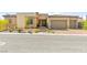 Inviting front exterior featuring a three-car garage and desert-friendly landscaping at 10906 Mila Landing Ave, Las Vegas, NV 89166