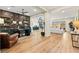 Open-concept living space with office, featuring modern décor and ample natural light flowing throughout the home at 10906 Mila Landing Ave, Las Vegas, NV 89166