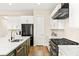 Well-lit kitchen featuring a green island, stainless steel appliances, and white cabinetry at 10906 Mila Landing Ave, Las Vegas, NV 89166