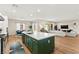 Open-concept kitchen island featuring white countertops, sleek green cabinets, and modern stainless steel appliances at 10906 Mila Landing Ave, Las Vegas, NV 89166
