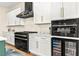 Close-up of a kitchen featuring stainless steel appliances, white cabinets, and stylish fixtures at 10906 Mila Landing Ave, Las Vegas, NV 89166