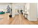 Bright living room showcasing hardwood floors and an open floor plan extending to the kitchen and dining area at 10906 Mila Landing Ave, Las Vegas, NV 89166