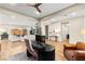 Open-concept living space boasts hardwood floors, a modern ceiling fan, and an adjoining office area at 10906 Mila Landing Ave, Las Vegas, NV 89166