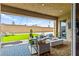 Relaxing outdoor patio with cozy seating, a fire pit, and a well-maintained lawn at 10906 Mila Landing Ave, Las Vegas, NV 89166