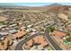 The aerial view displays a community with a mix of desert landscaping and mature vegetation at 1105 Malachite Ct, Henderson, NV 89011