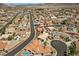 This aerial view shows a residential community with desert landscaping and a house with a private pool at 1105 Malachite Ct, Henderson, NV 89011