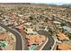 The aerial shot presents a residential community with well-maintained landscaping and a winding street at 1105 Malachite Ct, Henderson, NV 89011