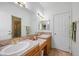 Bright bathroom with tile countertop and floors, and dual sinks at 1105 Malachite Ct, Henderson, NV 89011