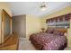 Well-lit bedroom with light yellow walls, carpeted floors and a ceiling fan at 1105 Malachite Ct, Henderson, NV 89011
