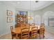 Dining room with tray ceiling, shuttered windows, and a wooden table with seating for eight at 1105 Malachite Ct, Henderson, NV 89011