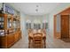 Dining room with tray ceiling, shuttered windows, and a wooden table with seating for eight at 1105 Malachite Ct, Henderson, NV 89011