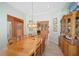 Dining room with tray ceiling, a wooden table with seating for eight and an ornate china cabinet at 1105 Malachite Ct, Henderson, NV 89011