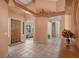 Inviting entryway with a wooden front door, tile flooring, and an open view into the living spaces at 1105 Malachite Ct, Henderson, NV 89011