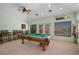 Spacious game room with a pool table, ceiling fan, and large windows at 1105 Malachite Ct, Henderson, NV 89011