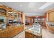 Bright kitchen with granite countertops, ample cabinets, and island with seating opening to living area at 1105 Malachite Ct, Henderson, NV 89011