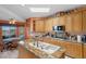 Bright kitchen with stone countertops, ample cabinets, and island with seating opening to dining area at 1105 Malachite Ct, Henderson, NV 89011