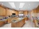 Spacious kitchen featuring a kitchen island, stainless steel appliances and granite countertops and skylights at 1105 Malachite Ct, Henderson, NV 89011