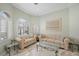 Bright living room with large arched windows, plantation shutters, and marble floors at 1105 Malachite Ct, Henderson, NV 89011