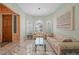 Living room with marble floors, arched windows, plantation shutters, and light green walls at 1105 Malachite Ct, Henderson, NV 89011