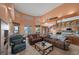 Comfortable living room with a fireplace, ample seating, and access to the kitchen and outdoor views at 1105 Malachite Ct, Henderson, NV 89011