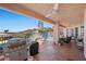 Inviting outdoor patio featuring a spiral staircase, a grill, ample seating, and stunning mountain views at 1105 Malachite Ct, Henderson, NV 89011