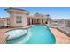 Resort style pool and spa with a covered patio, perfect for outdoor entertaining and relaxation at 1105 Malachite Ct, Henderson, NV 89011