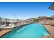 Sparkling pool with a waterfall feature surrounded by desert landscape, offering a tranquil oasis at 1105 Malachite Ct, Henderson, NV 89011