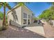 Large backyard with patio, lush palm trees, and attractive landscaping at 1116 Avellino Ln, Las Vegas, NV 89144